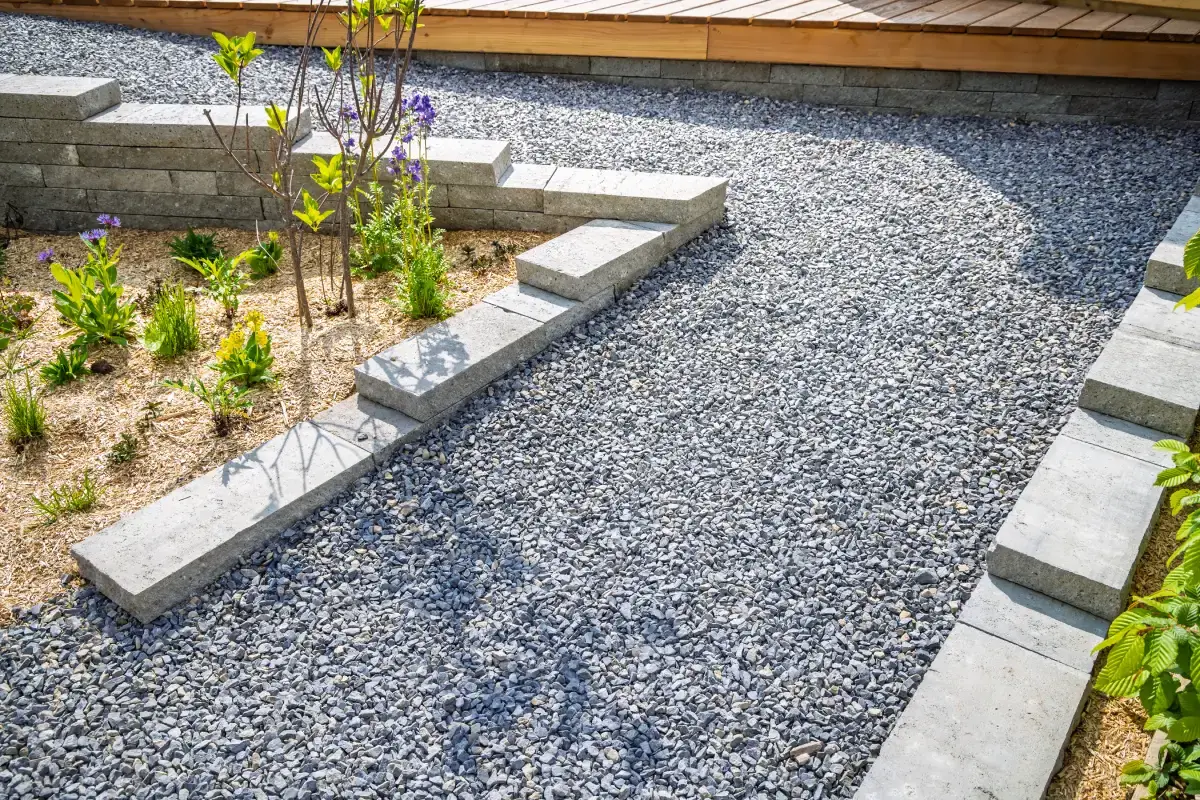Gravel path installation in a landscaped residential garden
