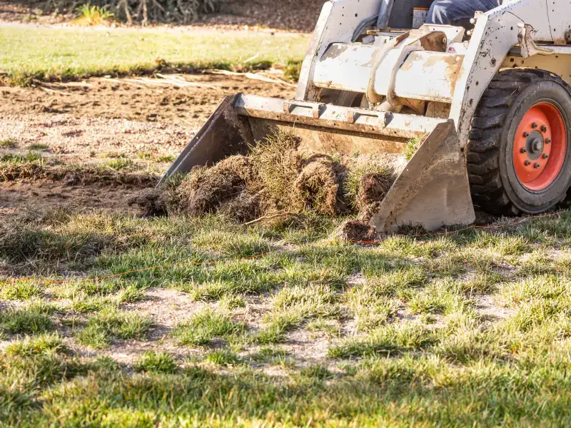 Skid steer removing sod and grading for site prep in the Northern Beaches, NC
